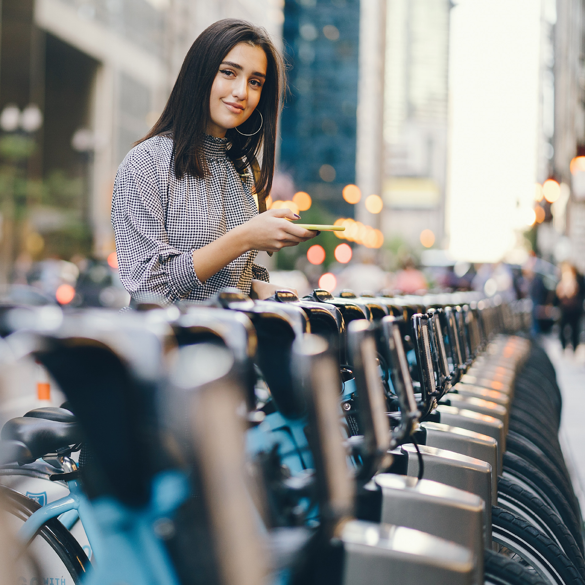 b2-ride-girl renting a city bike from a bike stand